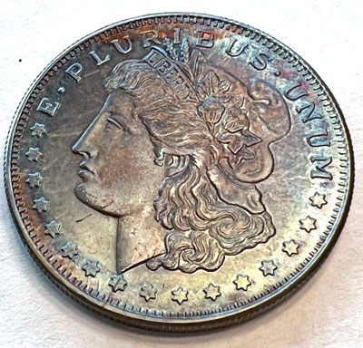 Morgan silver round obverse heavily toned Morgan silver round obverse heavily toned